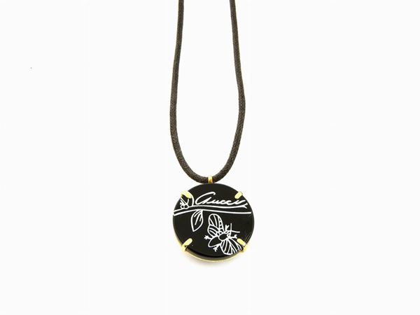 Yellow gold and leather Gucci necklace with engraved and painted onyx pendant