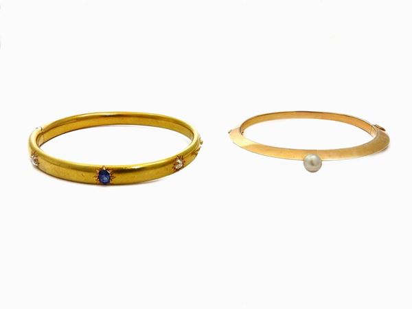 Two yellow gold bangles with diamonds, sapphire and likely natural pearl