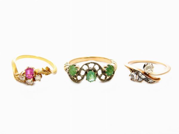 Three yellow gold rings with diamonds and colour stones