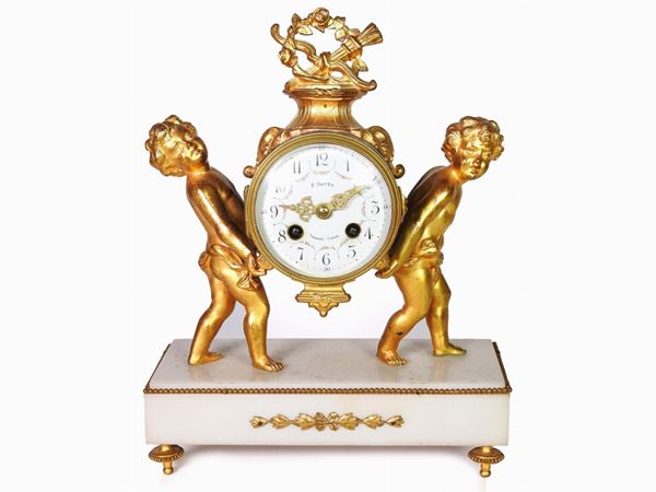 A Gilded Metal and Alabaster Mantel Clock
