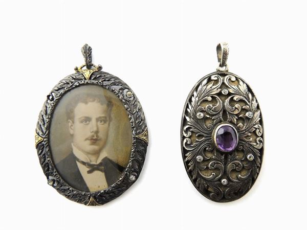 Two silver and metal locket pendants
