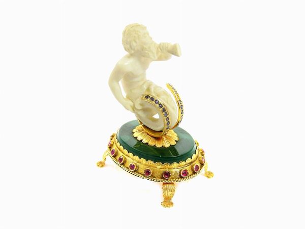Ivory sculpture on yellow gold, malachite, rubies and sapphires basement