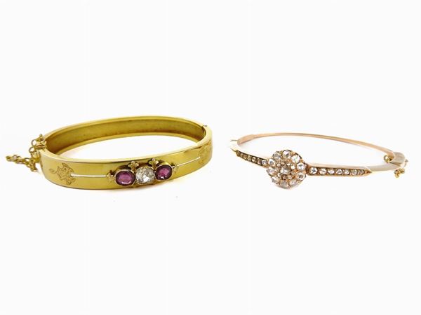Two yellow gold bangles with diamonds and rubies