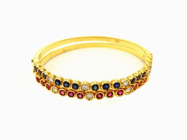 Pair of yellow gold Cardi bangles with diamonds, rubies and sapphires