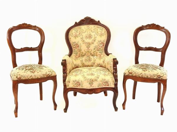 A Set of Four Walnut Chairs and an Armchair