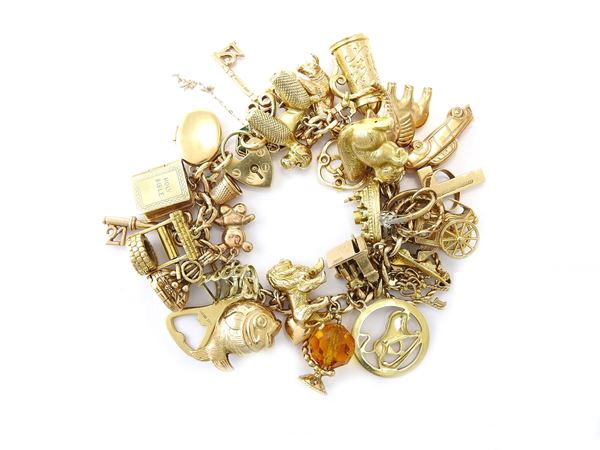 Mostly 9KT yellow gold "charms" bracelet
