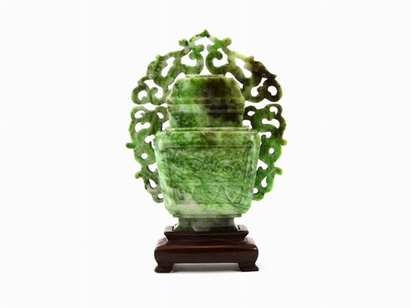 Green and white jade vase with lid on wooden carved base