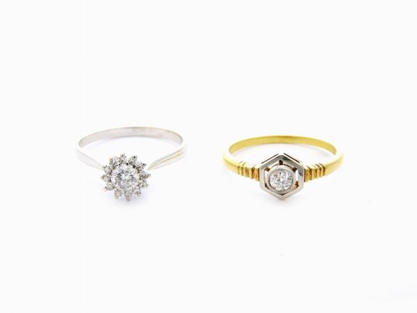 Two rings, a pin and earrings in white and yellow gold with diamonds