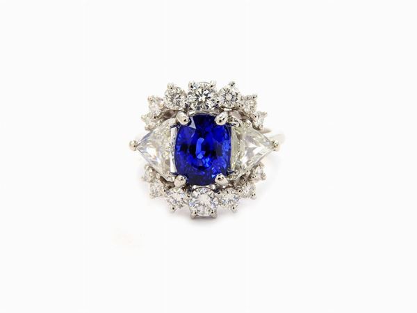 Platinum daisy ring with diamonds and natural sapphire