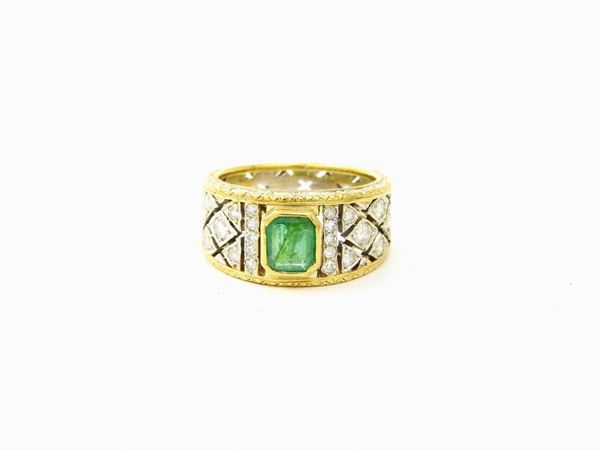 White and yellow gold ring with diamonds and emerald
