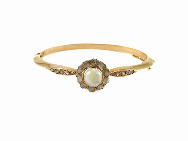 Yellow gold bangle with diamonds and likely natural pearl