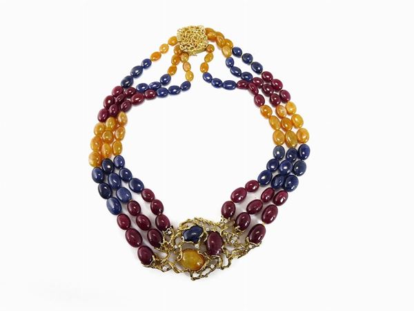 Three strands multicoloured corundums necklace with yellow gold and diamonds central panel and clasp