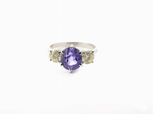 White gold ring with fancy yellow diamonds and lilac colour corundum