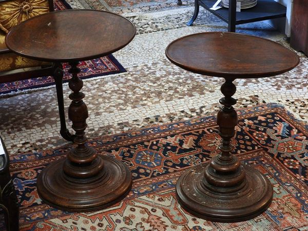 A pair of round walnut tables