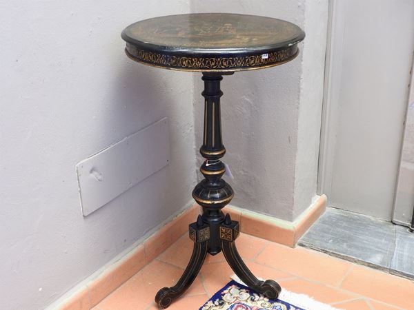 A Round Ebonised Wooden Table