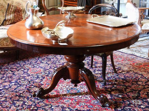 A Round Extendible Walnut Dining Table