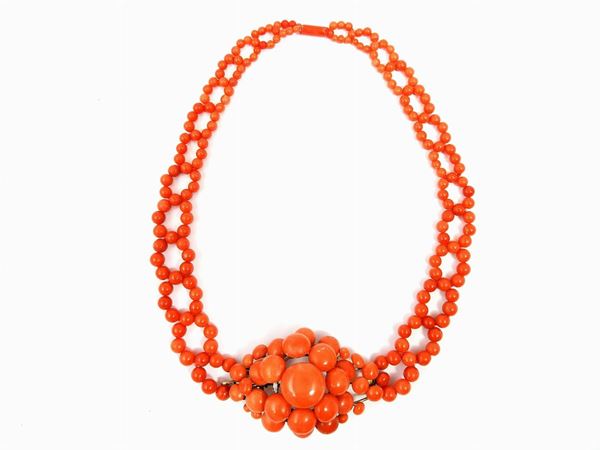 Graduated orange coral necklace with central floral motif