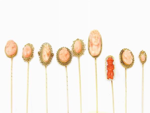 Nine 12KT yellow gold pins with red and pink coral cameos or cabochons