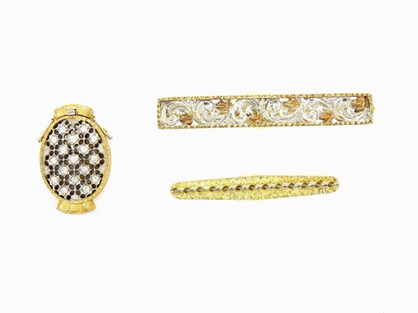 Two white and yellow gold tie clips and a clasp with diamonds