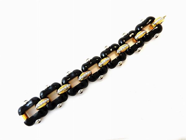 White and yellow gold bracelet with diamonds, red stones and onyx