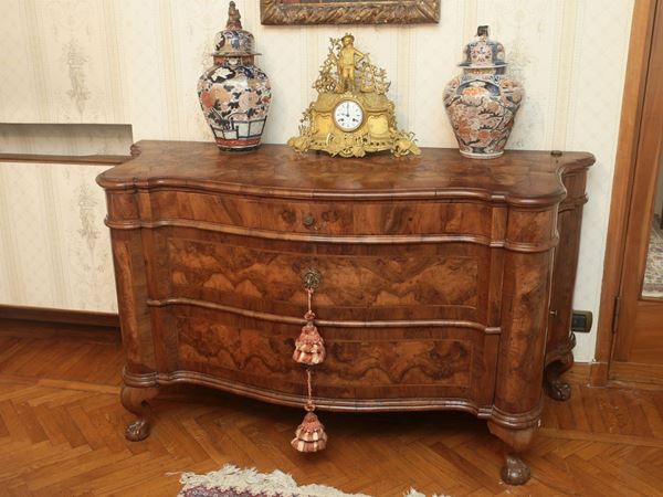 A walnut veenered chest of drawers
