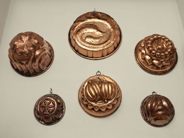A group of six copper pudding molds
