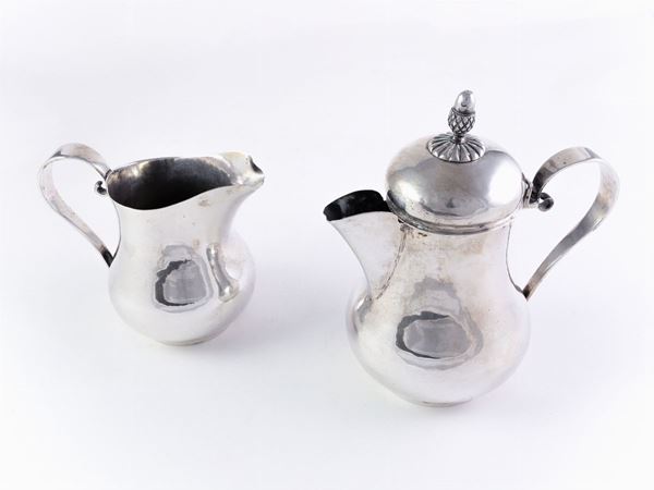 A silver coffeepot and milkjug