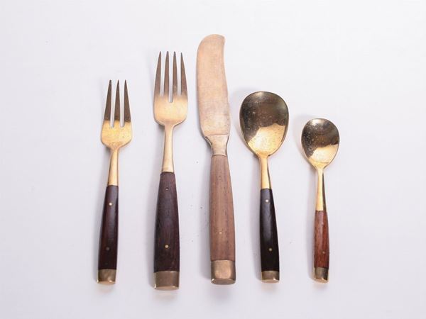 A wood and brass cutlery set