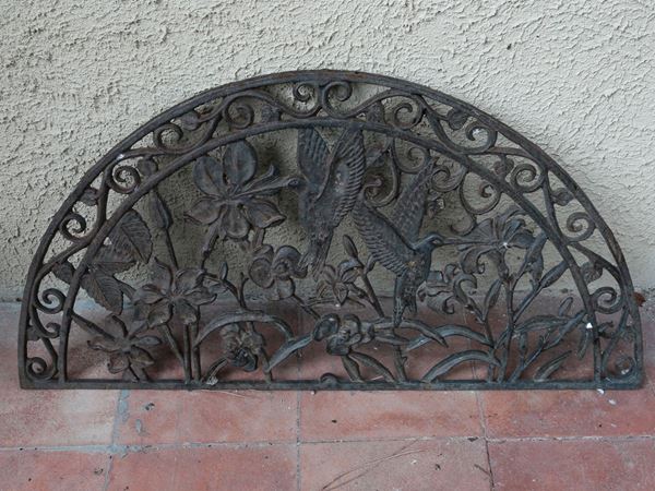 A pair of cast iron doormats