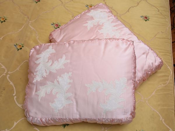 A couple of pink satin pillows