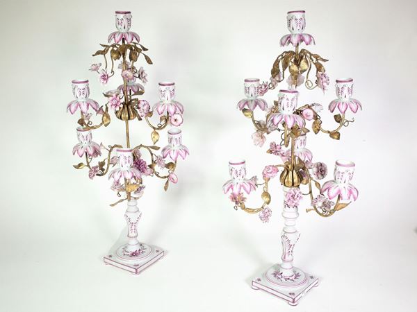A couple of gilded metal and polychrome porcelain candelabras