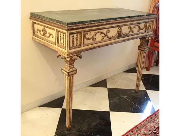A couple of lacquered and gilted console