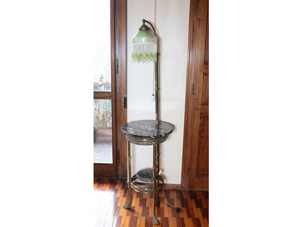 An uprignt lamp with small table