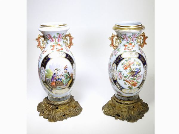 A couple of polychrome porcelain vases