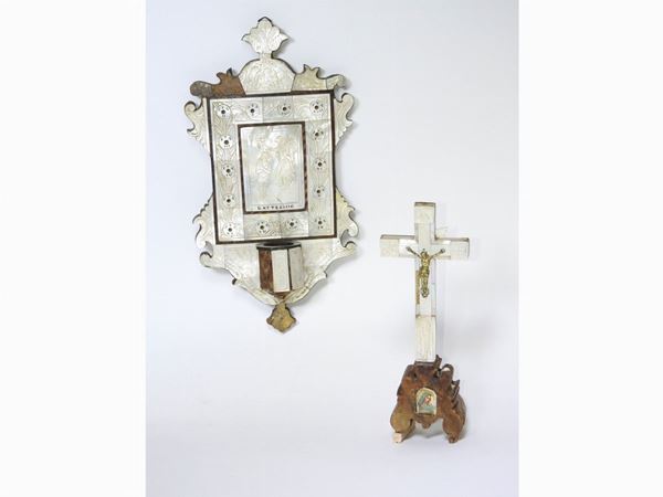 A wood and mother of pearl font and crucified Christ