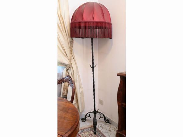 A wrought iron floor lamp