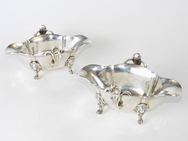 A couple of silver sauce boats