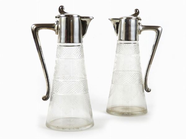 A couple of cutted crystal and silver pitchers