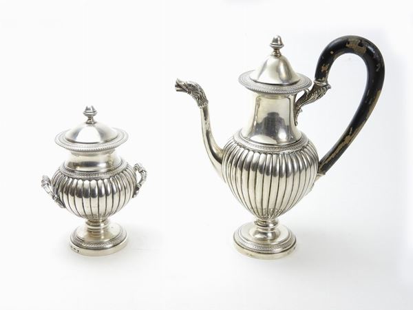 A silver coffeepot and sugar bowl