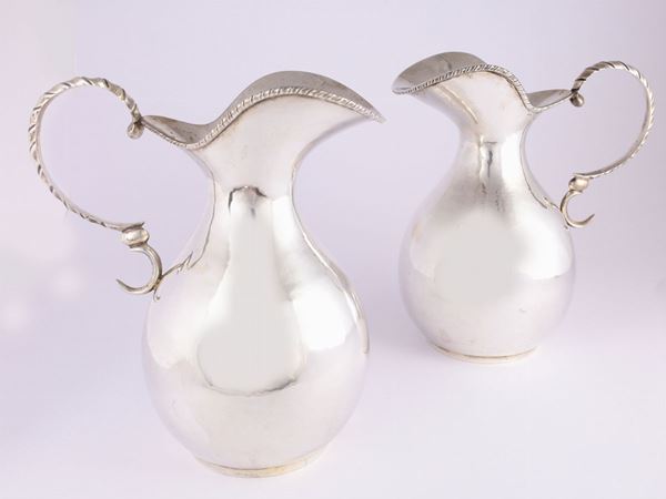 A pair of silver pitchers