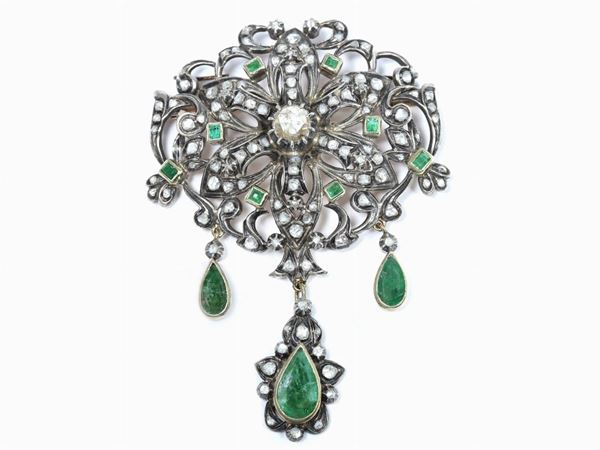 Yellow gold and silver brooch with diamonds and emeralds
