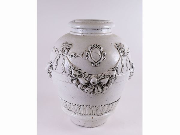 A white enamelled terracotta vase