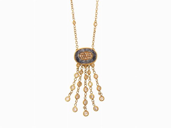 Yellow gold necklace with central blue topas and diamonds