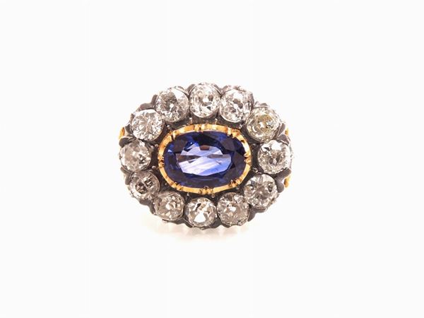 Yellow gold and silver daisy ring with diamonds and sapphire