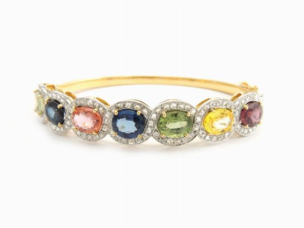 White and yellow gold bangle with diamonds and multicoloured sapphires