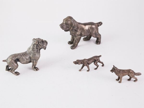 Four silver dog shaped figures collectables