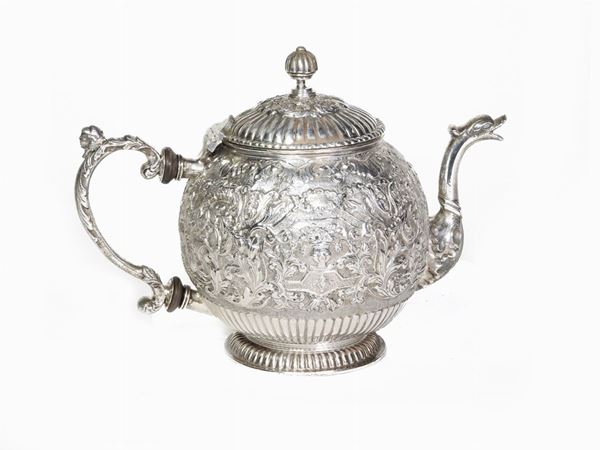 A smal silver tea pot