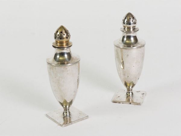 A pair of silver salt and pepper shakers