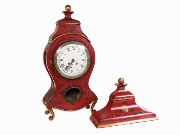 A dark red lacquered wood shelf clock