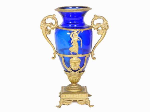 An amphora blue crystal and golden tole vase